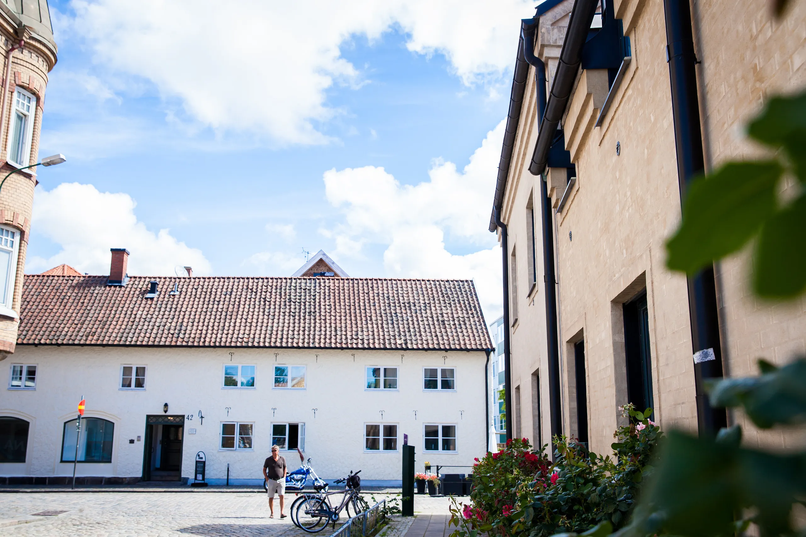 Stort vitt hus med rabatt och cykelställ