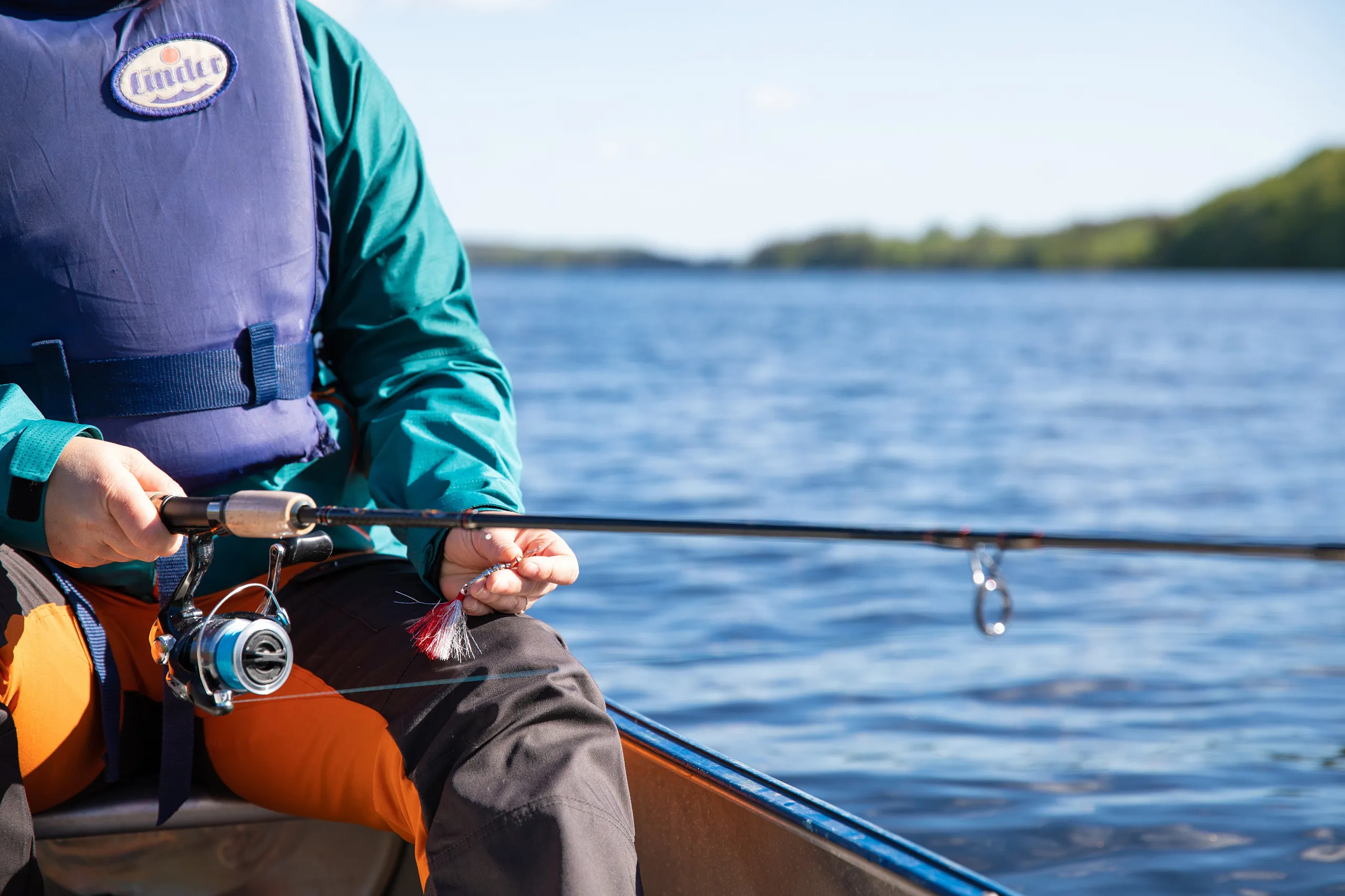 person i båt med fiskespö